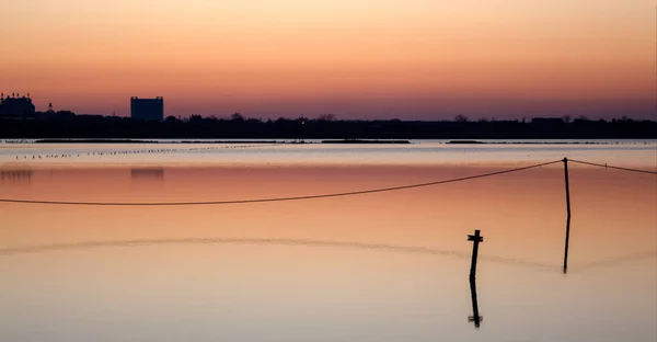 A series of landscapes of a salt lake in a seaside resort after sunset. With reflections. Pomorie resort, Bulgaria.