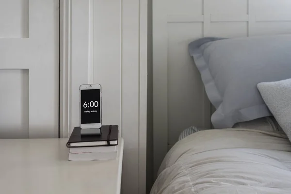 bedside table phone as alarm