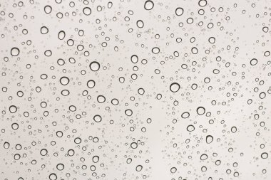 Renkli cam arabanın üzerine yağmur damlaları. doku