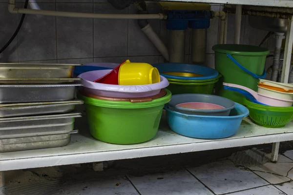 utility dishes washed in the dishwasher area, in the kitchen of the restaurant