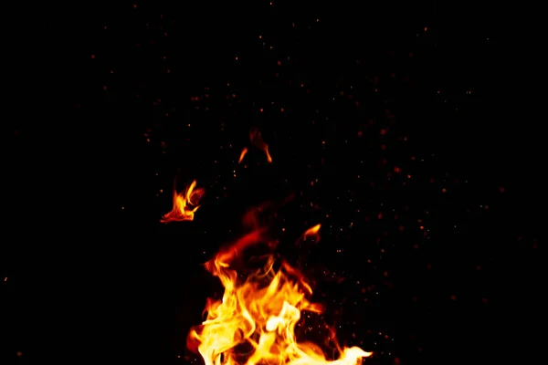Fogo e faíscas, a partir de uma fogueira em um fundo noite escura, fro — Fotografia de Stock