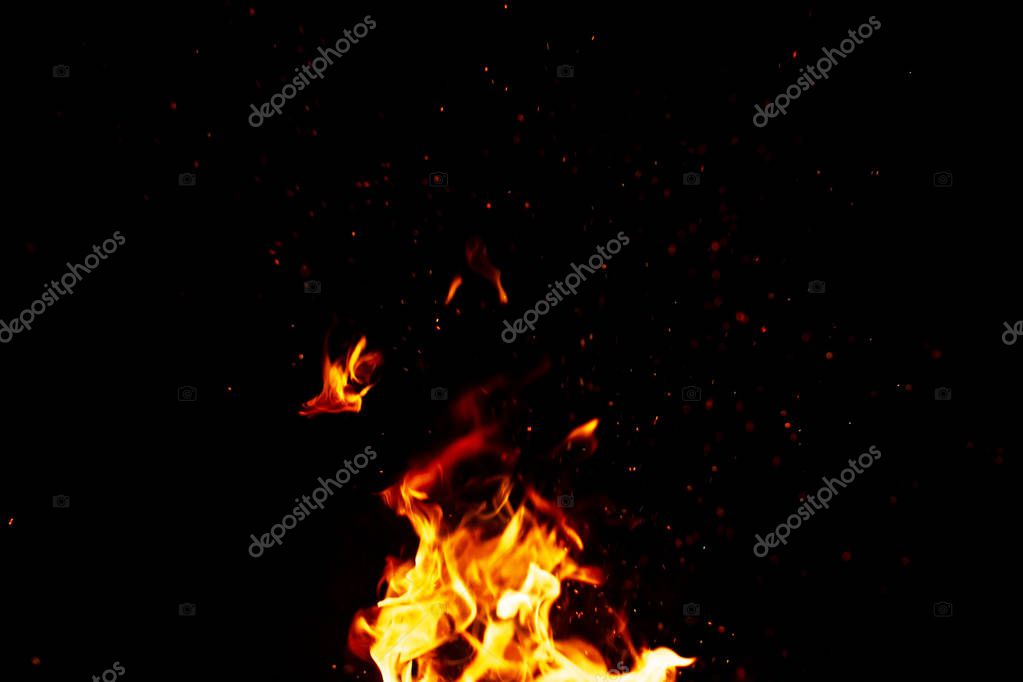 Fire and sparks, from a campfire on a dark night background, fro