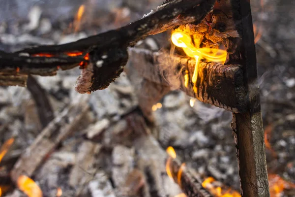 burnt fence close-up on the ashes of a large fire, on a blurred