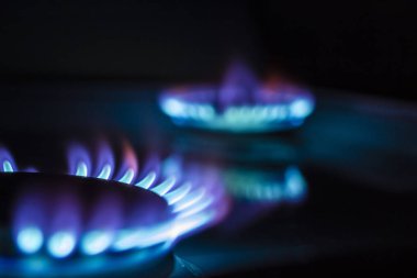 Gaz ocağına 100 dolarlık banknot ve yanan bir ateş.