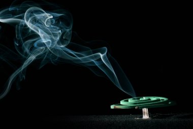 incense burning in a dark room clipart