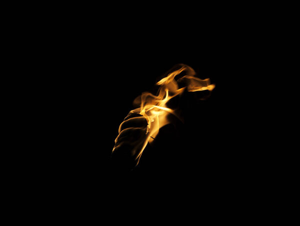 Flame of a torch in the dark on a black background, only the fire is visible