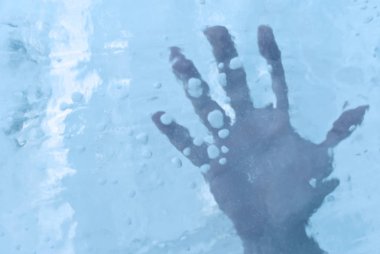 human hand in ice or under the ice surface clipart