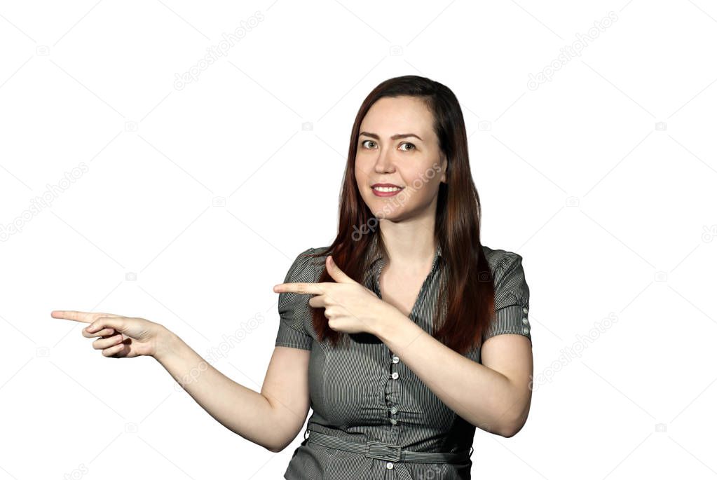 the girl on a white background looks at the viewer and points with two index fingers aside