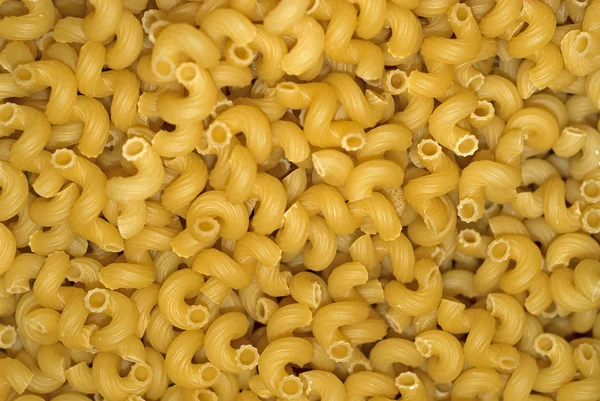 Hintergrund Ein Haufen Leicht Gelber Trockener Pasta Ohne Verpackung — Stockfoto