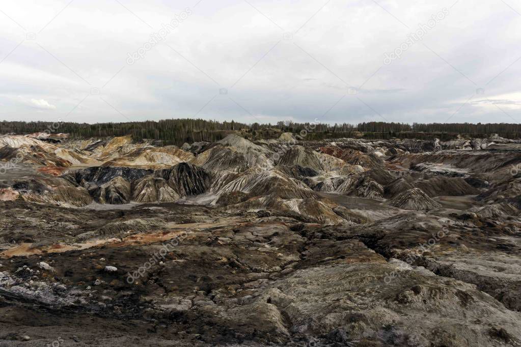 multicolored industrial dumps at the mining site of minerals by open method