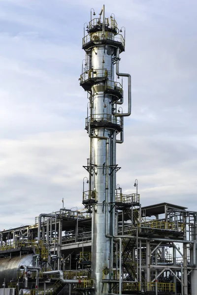 Fragment of a modern thermal cracking column against the sky