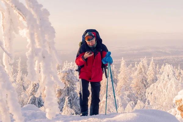 スマート フォンを介して誰かと通信するハイカー冬雪に覆われた山の風景 — ストック写真