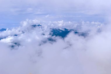 Neredeyse bulutlar tarafından gizli bir dağ aralığının üstten görünüm