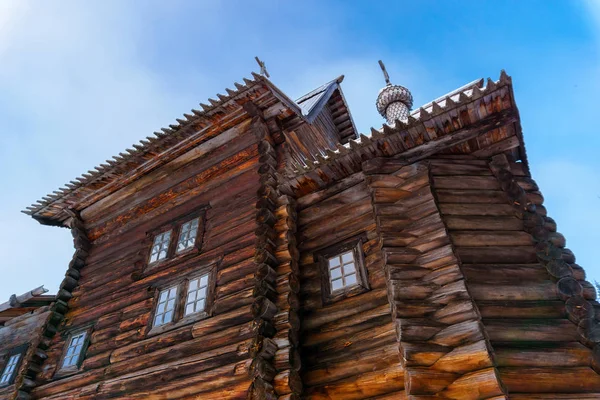 fragment of the facade of old Russian wooden village church against the sky