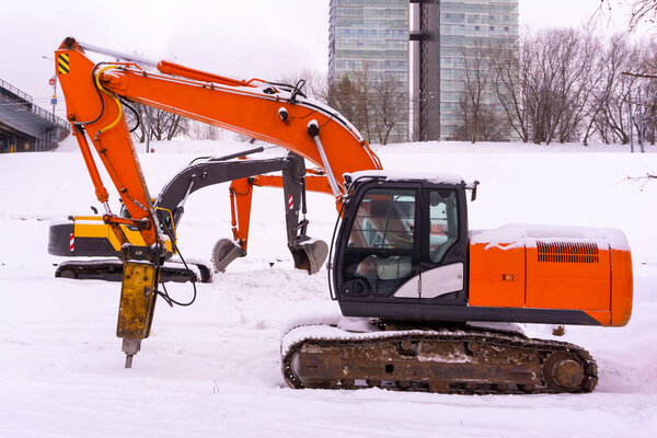 excavators on a winter building site