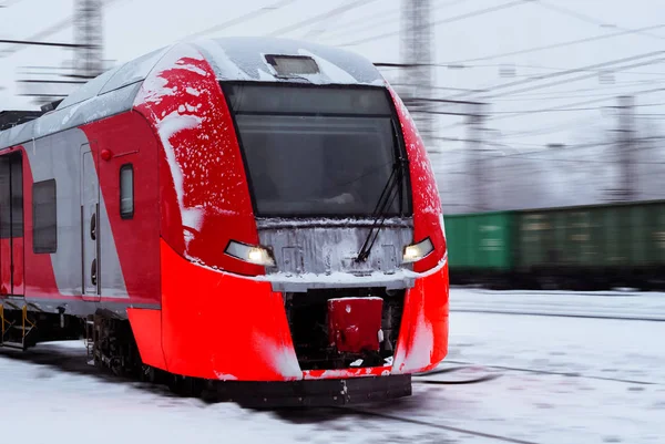 ice-covered multiple-unit train rides by rail in winter