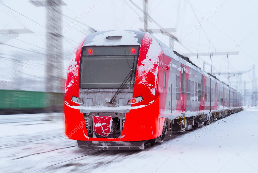 ice-covered multiple-unit train rides by rail in winter