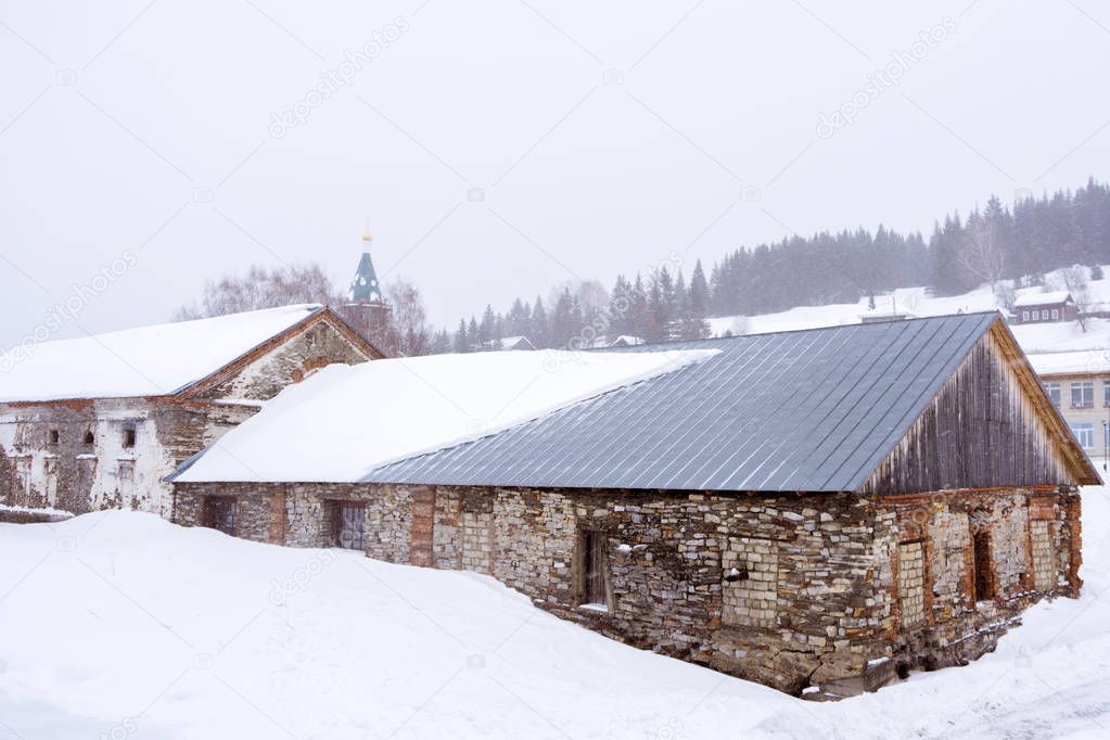 ancient factory workshops in a winter landscape