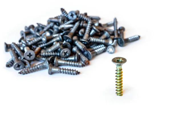 Golden modern screw screwed into a white surface on the backgrou — Stock Photo, Image