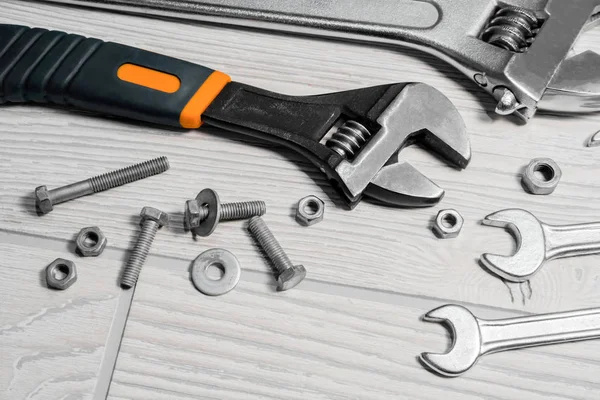 adjustable spanners and wrenches, nuts and bolts on the table