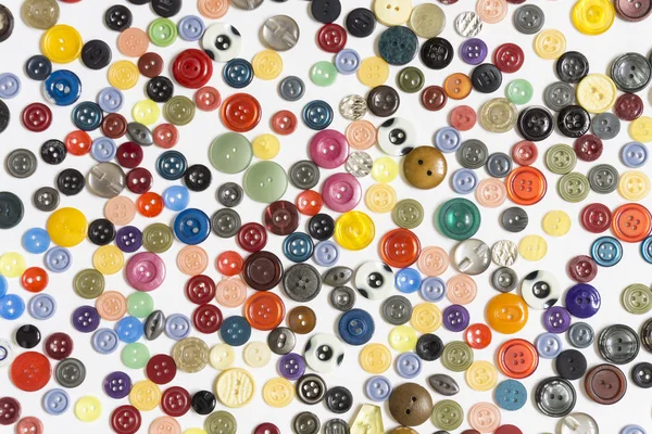Sfondo - bottoni multicolori su una superficie bianca — Foto Stock