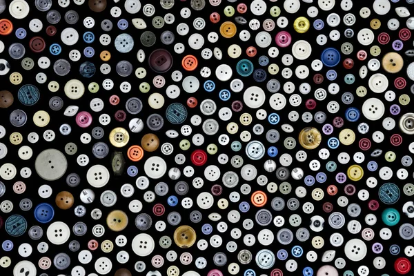 Fondo - botones multicolores en una superficie oscura — Foto de Stock