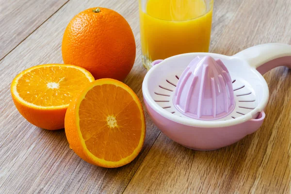 Two oranges, reamer and juice — Stock Photo, Image