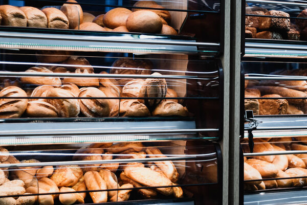 background - shelves with fresh bread in a grocery store
