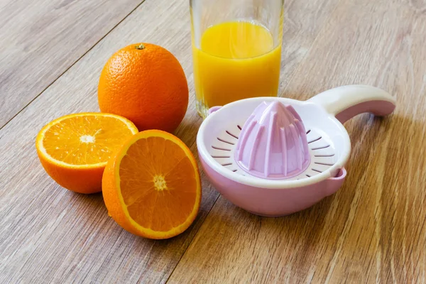 Two oranges, reamer and juice — Stock Photo, Image