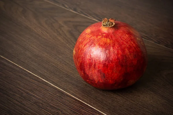 Two pomegranate fruits on a dark surface — Stock Photo, Image