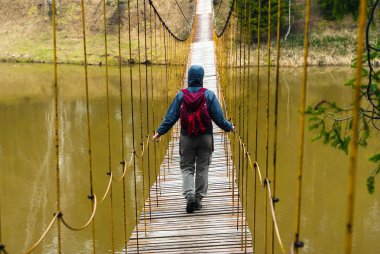 the way over the hanging bridge over the spring river clipart