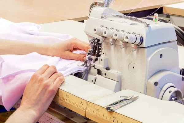 Industrial overlock sewing machine in work — Stock Photo, Image