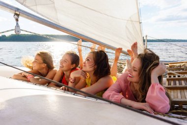 young women relax on a sailing yacht clipart