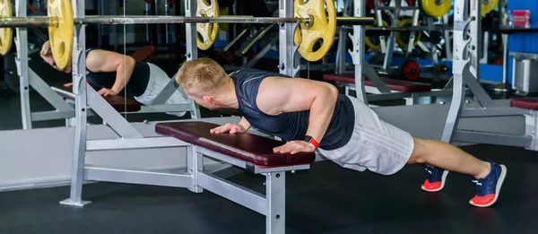 man does push-up exercise in the gym