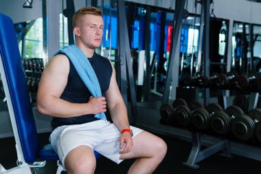 atlet ağırlık eğitim setleri arasında yatıyor