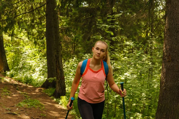 Jonge vrouw trekking in een berg woud — Stockfoto