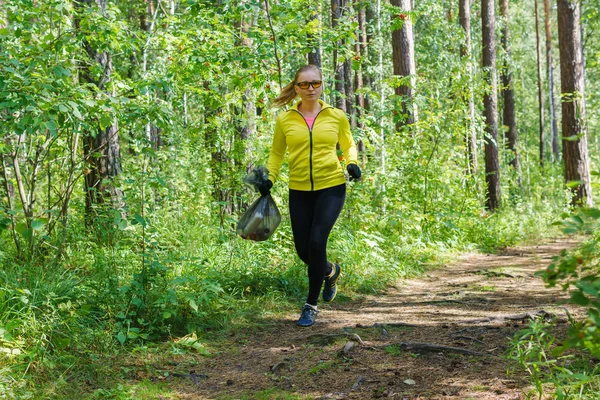 parkta genç kadın plogging