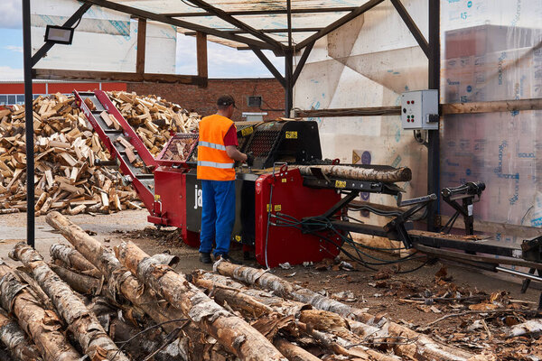 Perm, Russia - May 29, 2020: modern firewood processor in operation