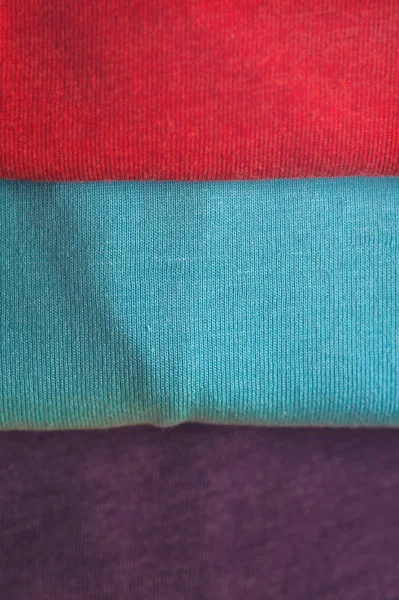 Stack of colorful t-shirts, close up