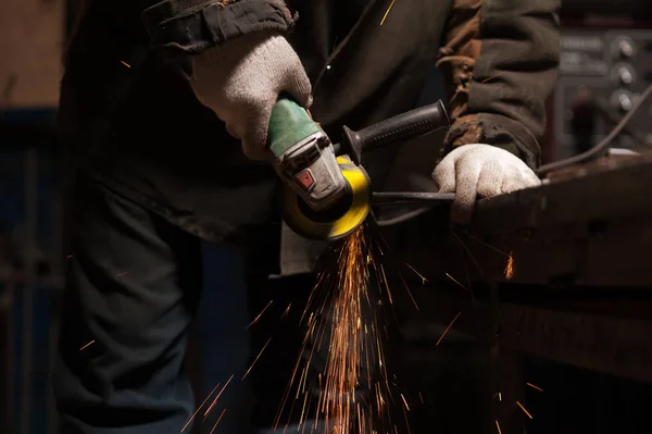 Blacksmith Polishes Metal Products Using A Grinding Machine