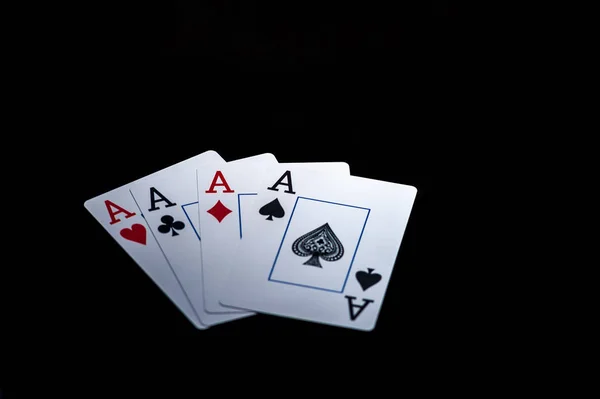 Four aces, playing cards on black table — Stock Photo, Image