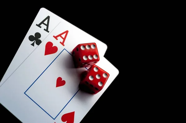 Close-up - Two aces, playing cards and red gaming dices on black table. — Stock Photo, Image