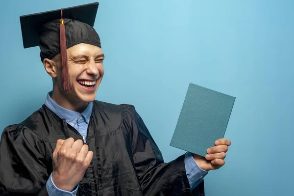 Graduate man with eyeglasses holding up a diploma — Stock Photo, Image