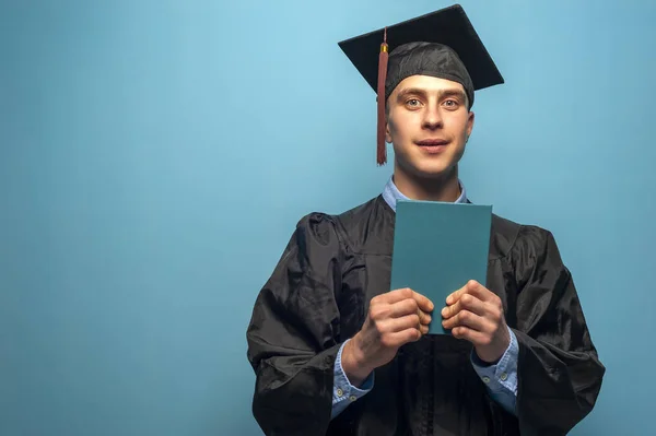 Graduate male student wearing black mantle and mortarboard — Stock Photo, Image