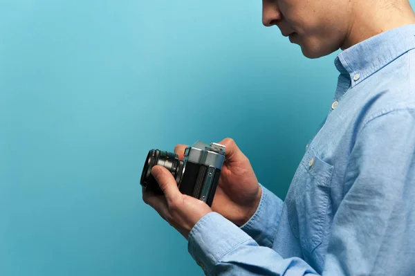 Male photographer examining his new camera