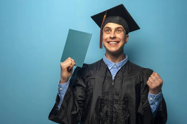 Graduate man with eyeglasses holding up a diploma — Stock Photo, Image