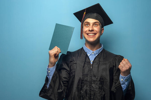 Graduate man with eyeglasses holding up a diploma