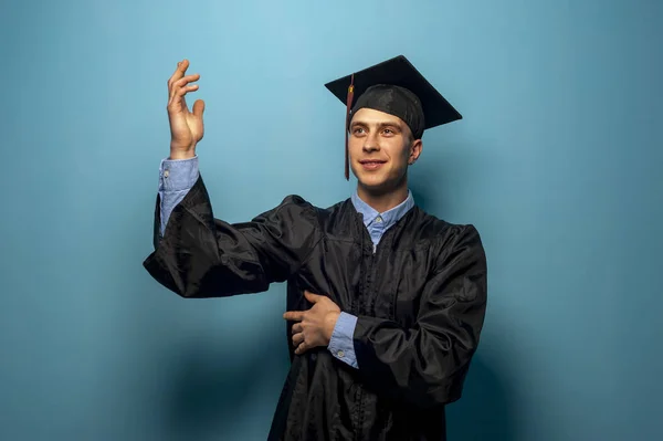 Male student graduate isolated on blue background — Stock Photo, Image