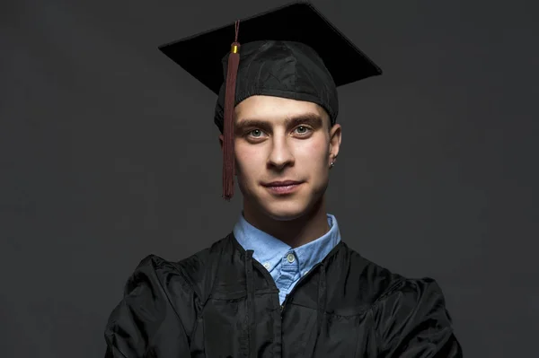 Portrait of Caucasian male student wearing black mantle and blue shirt — Stock Photo, Image