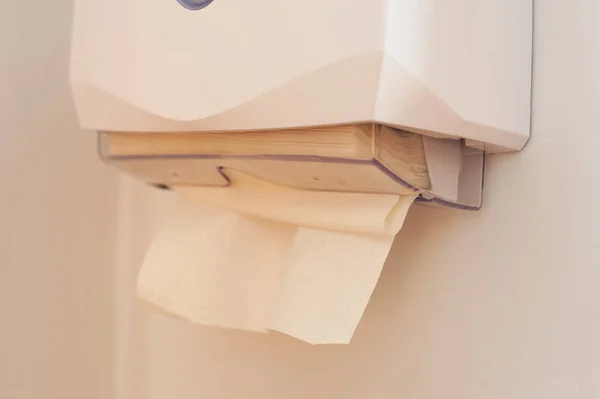 Close-up of paper towels in a dispenser hanging on the wall — Stock Photo, Image